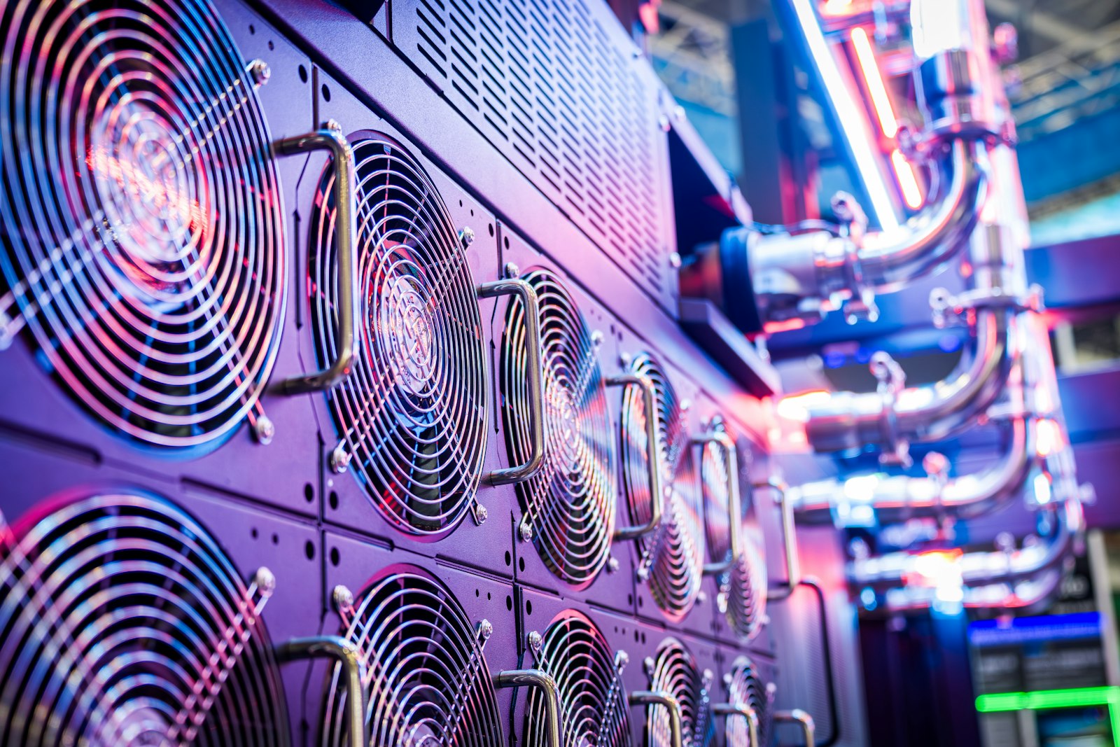 Rows of humming server racks in a data center, the physical infrastructure that AI agents must pay to run on