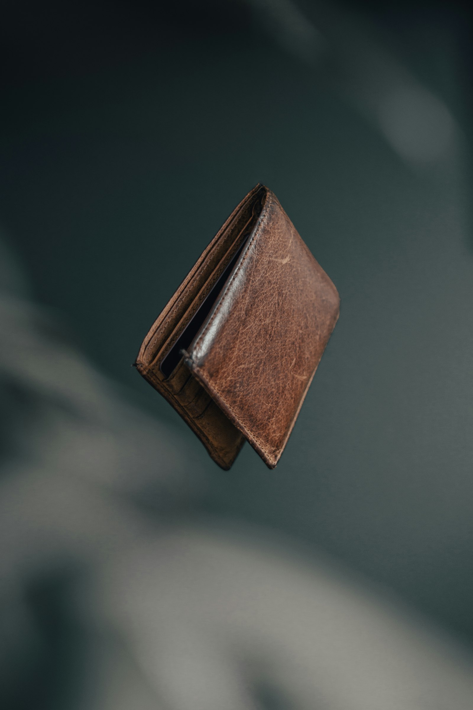 An open wallet holding several payment cards, standing on a desk